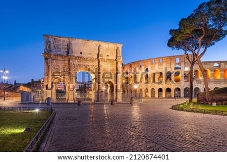 Rome, Italy at the Arch of Constantine and the Colosseum at twilight.