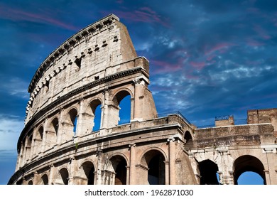 Rome, Italy. Arches archictecture of Colosseum (Colosseo) exterior with blue sky background and clouds.