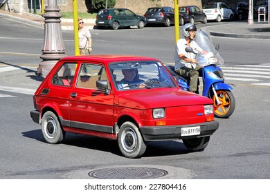 ROME, ITALY - AUGUST 1, 2014: Red tiny retro car Fiat 126 at the city street.