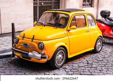 ROME, ITALY - AUGUST 1, 2014: Yellow Tiny Retro Car Fiat 500 At The City Street.