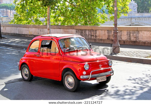 ROME, ITALY - AUGUST 1, 2014: Red tiny car Fiat\
500 at the city street.