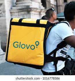 Rome, Italy - August 15, 2017: Glovo delivery man at work on bike. Glovo is a Rome-based online food delivery company
