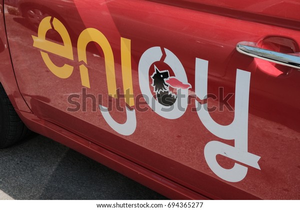 Rome, Italy - August 9, 2017: Enjoy logo. Enjoy is\
an Italian car sharing service provided by Eni. The system offers\
exclusively Fiat 500 vehicles with one-way point-to-point rentals\
charged by minute