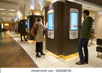 ROME, ITALY - CIRCA NOVEMBER, 2017: customers use self-ordering kiosks at McDonald's restaurant in Rome. 