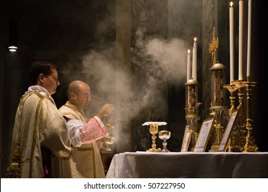 ROME, ITALY - CIRCA OCTOBER 2016 - Catholic priest celebrating the old rite traditional latin mass with deacon and subdeacon, censing the altar in the church of St Pancratius, Rome
