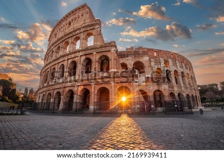 Rome, Italy at the Colosseum Amphitheater with the sunrise through the entranceway. 