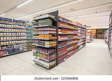 ROME, ITALY. December 05, 2018: Lanes of shelves with goods products inside a MA supermarket in Italy in Rome. Variety of preserves and pasta. Shelves full and tidy.