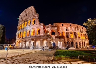 Rome, Italy - January 10 2022: Night Panorama Of The Colosseum In Rome In The Park Towing Ancient Famous Roman King Builder Of The Famous Arco
