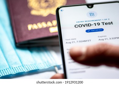 Rome, Italy, - January 17 2021: Covid Test Requirements And Procedures. Covid-19 Immunity Health Pass App. Vaccine Certificate Or Passport App Displayed An A Smartphone With Passport And Facial Mask