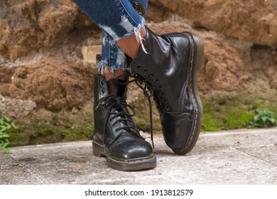Rome, Italy - January 22, 2021: Classic black leather Dr. Martens AirWair boots. Dr Martens is an English footwear, accessories and clothing brand