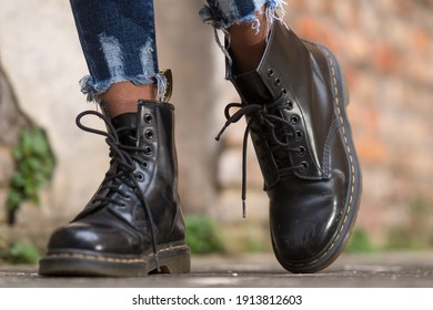 Rome, Italy - January 22, 2021: Classic black leather Dr. Martens AirWair boots. Dr Martens is an English footwear, accessories and clothing brand