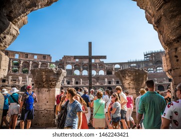 Rome, Italy - July 14th 2015: Crowd of tourists on a hot, sunny day at the entrance of the Colosseum, also known as the Flavian Amphitheatre or Colosseo, an oval amphitheatre east of the Roman Forum