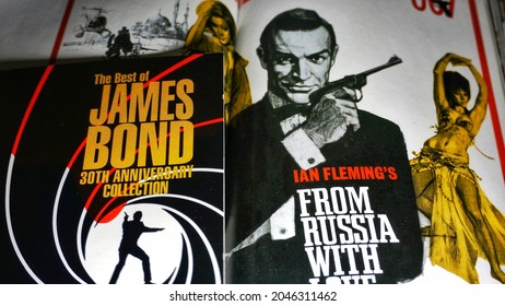 Rome, Italy - June 25, 2019, Detail Of The Cover Of The J.B. 007 And Detail Of The Poster Of The Film By Sean Connery In A 007 From Russia With Love.