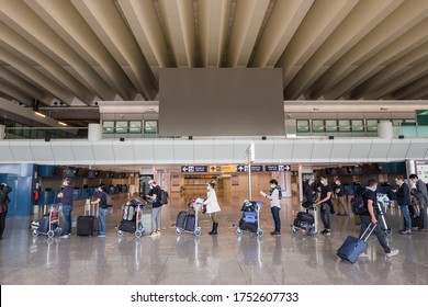 Rome, Italy - June 3, 2020: First Passengers After Covid 19 Pandemic Lockdown In Rome Fiumicino Airport. Line Of People Waiting For Boarding In Airport Keeping One Meter Social Distance.