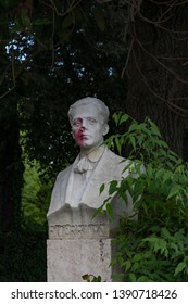 Rome, Italy - May 2 2019: A Damaged By Vandals Concrete Bust Of R. Corridoni With Red Paint On The Face Looking Like Blood In The Park At Villa Borghese