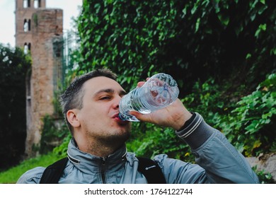 Rome, Italy, May 2019: Male Tourist Drinks Water From A Bottle On Palpatine Hill