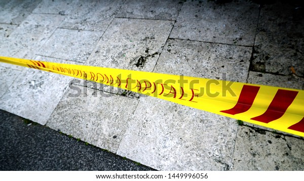 Rome, Italy - May 29, 2019: Yellow tape of the\
Rome capital police, to delimit zones inhibited to the passage.\
with marble flooring in the\
background