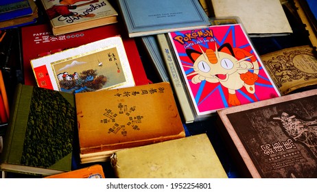 Rome, Italy - May 5, 2019: Group Of Collectible Books Such As Pinocchio, And Pokemon Collectible Cards On The Counter Of The Second-hand Market In Porta Portese In Rome