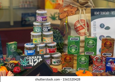 ROME, ITALY - November 10 2019: Display Case In A Retail Store Selling Many Types Of CBD Oil Products, Made From Hemp. Legal Marijuana Buds And Hash For Sale. Marijuana Cannabis Liquid For Vaping.