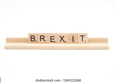 Rome, Italy - November 2019: Brexit Text In Wooden Letters Scrabble Game Characters On Wood Support Isolated On White