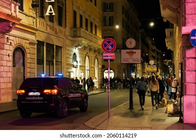 Rome, Italy - October 10 2021: Carabinieri Police Car Patrolling At Night In The City Center. Italian Military Force Dark Blue Vehicle With Blue Sirens Lit And Red Stripe On Side, On The Roman Capital