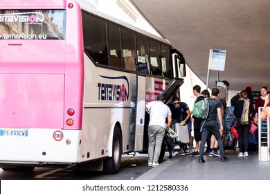 Rome, Italy - September 4, 2018: Entrance to Termini rail station, summer day, people tourists walking boarding Terravision shuttle bus to airport