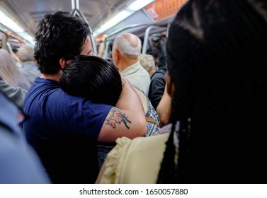 Rome, Italy-september, 2019, Couple Hugging While Standing In A Crowded Train Carriage During A City Commute In A Transportation And Travel Concept