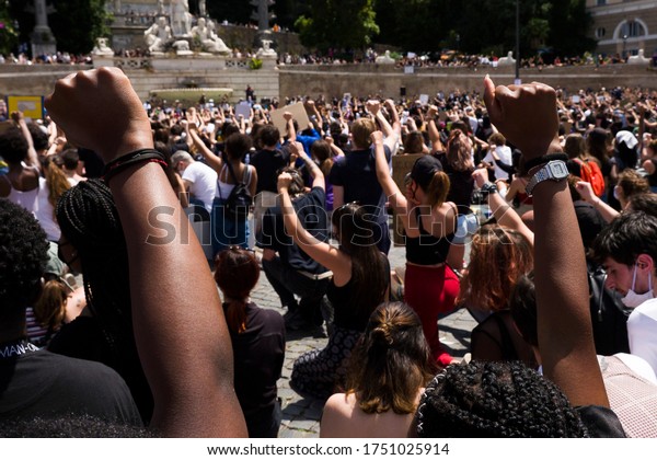 Rome - June 22, 2020: against racism and the\
killing of Geoge Floyd. The participants remained on their knees\
and with a high fist for 8\'46 \'\' the time that the Minneapolis\
policeman kept Floyd stuck