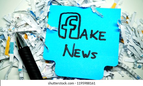 Rome, October 05, 2018: Facebook Logo As F Of Fake News On Blue Sticker, With Scraps Of Paper