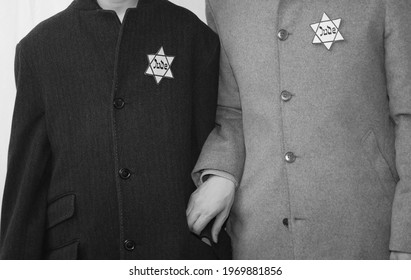 Rome, RM, Italy - March 10, 2019: historical reenactment with father and son in old 40s clothes and the star of David sewn on the clothes