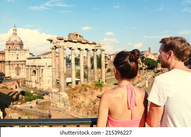 Rome Tourists Looking At Roman Forum Landmark In Rome. Couple Sightseeing On Travel Vacation In Rome, Italy. Happy Tourist Couple, Man And Woman Traveling On Holidays In Europe.