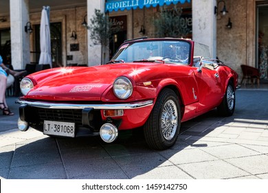 Rome,Italy - July 20, 2019:On occasion of  Rome capital city Rally event, an exhibition of vintage cars has been set up with the beutiful red car model Spitfire 1500 from Triumph Motor Company  - Shutterstock ID 1459142750
