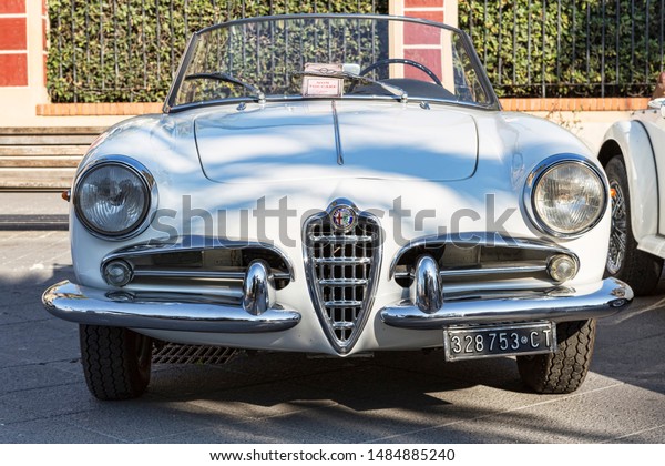 Rome,Italy\
- July 21, 2019: Rome capital city Rally event, an exhibition of\
vintage cars with beautiful white car model Alfa Romeo Giulietta\
Spider 1300 manufactured by Italian Alfa\
Romeo