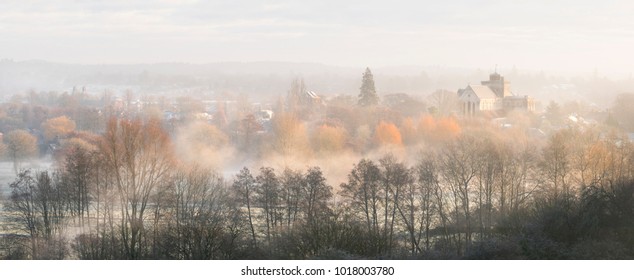 Romsey Abbey In Morning Mist In Hampshire.