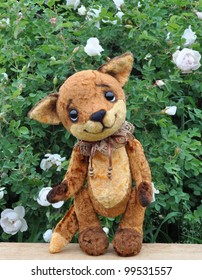 Ron Fox Cub On A Board Among Flowers. Handmade, The Sewed Plush Toy