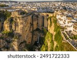 Ronda, Spain. Aerial view of the New Bridge over Guadalevin River in Ronda medieval town at sunrise, Andalusia, Spain. Famous UNESCO heritage city and Puente Nuevo bridge at sunset