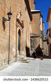 RONDA, SPAIN - MAY 5, 2008 - View Of The Side Of Santa Maria Church In The Historic Old Town With An Elderly Spanish Woman Walking Her Dog, Ronda, Malaga Province, Andalucia, Spain, May 5, 2008.