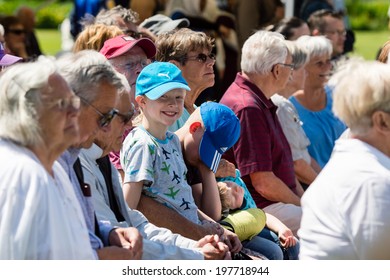 RONNEBY, SWEDEN - JUNE 06, 2014: National Day Of Sweden. Happy Girl In Crowd Looking At You With A Pretty Smile.