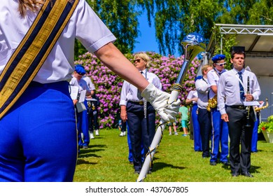 Ronneby, Sweden - June 6, 2016: The Swedish National Day Celebration In Public Park. The School Orchestra Seen From Behind The Female Drum Major Holding A Mace In Gloved Hand.