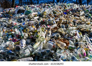 Ronneby, Sweden - March 27, 2017: Documentary of public waste station. Large pile of clear glass destined for recycling.