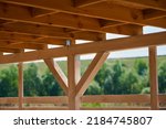 Roof of beams in a wooden gazebo under a canopy