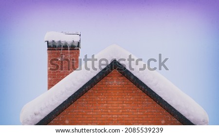 Roof and brick chimney covered with snow in winter