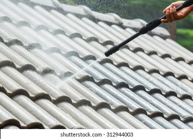 Roof cleaning with high pressure water cleaner