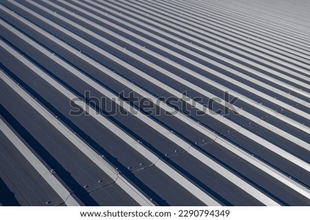 Roof covered with paint-coated trapezoidal sheet in graphite color. Foto stock © 