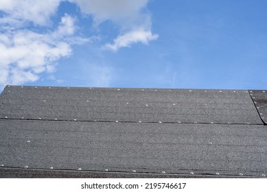roof covered with tar paper, black tar paper on the roof - Shutterstock ID 2195746617