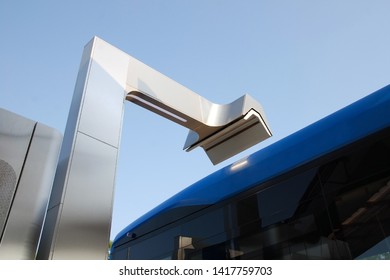 Roof Of Electric Bus Ready To Charge Battery At Charging Station And Electric Vehicle Charger, Close Up