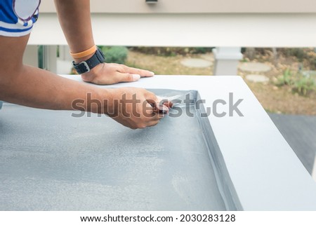 Roof floor or deck painting work consist of painter man or worker person, bristles brush. That house construction to coating surface concrete with waterproof and colour by professional, contractor.
