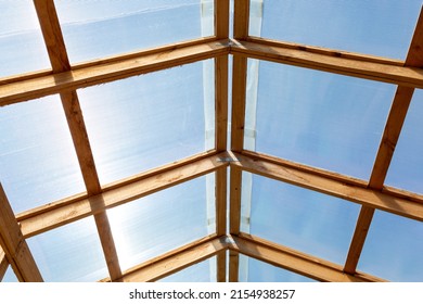 The Roof Of A Greenhouse, Barn Or Other Agricultural Building Is Made Of Transparent Polycarbonate And Wooden Boards. Bottom View