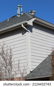 Roof Gutters And A Downspout To Move Water Away From The House