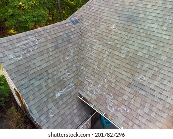 Roof with hail damage and chalk markings from inspection